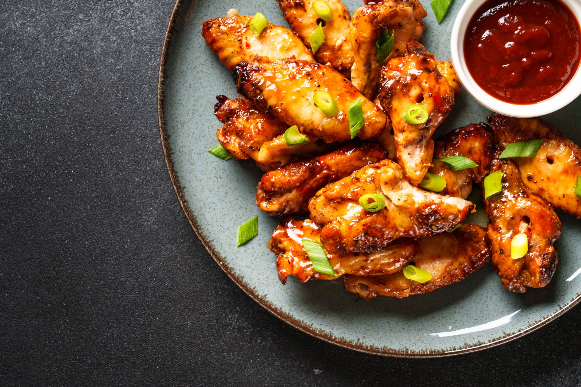 Chicken wings in bbq sauce grilled .