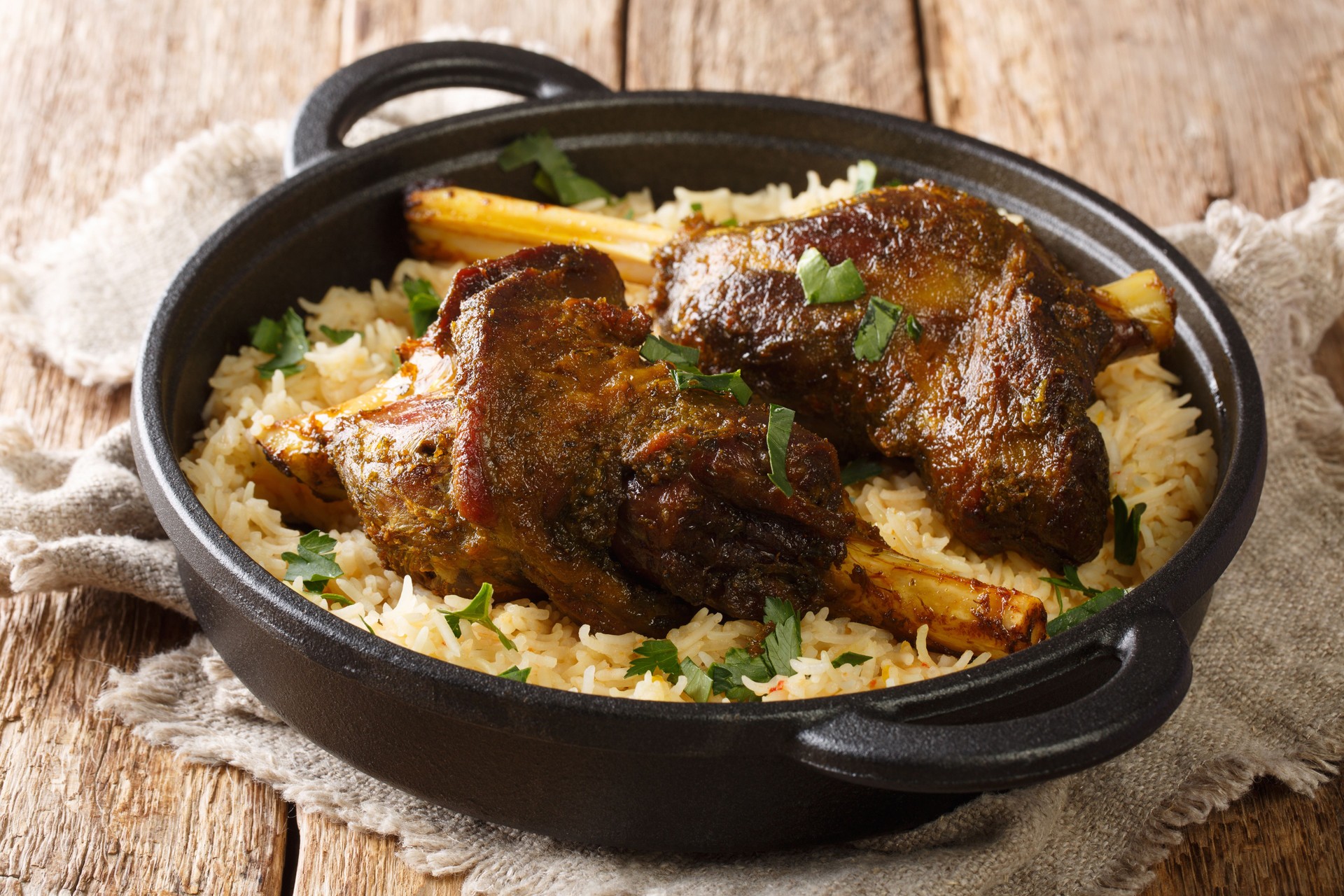 Lamb haneeth is a traditional dish with basmati rice close-up in a frying pan. horizontal