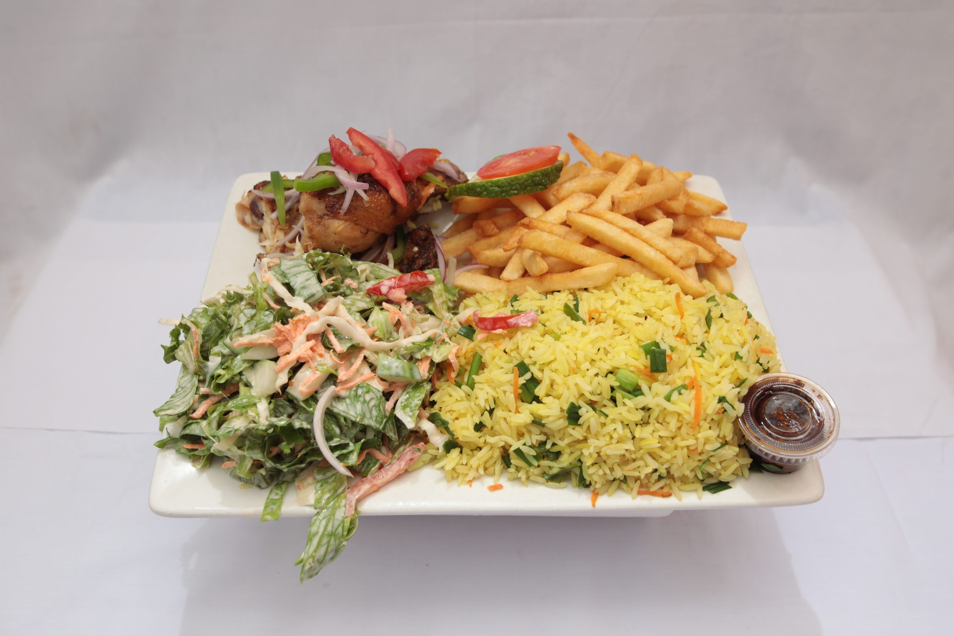 Chicken meal with rice lunch Biryani rice dish with oriental french fries Fried chicken
